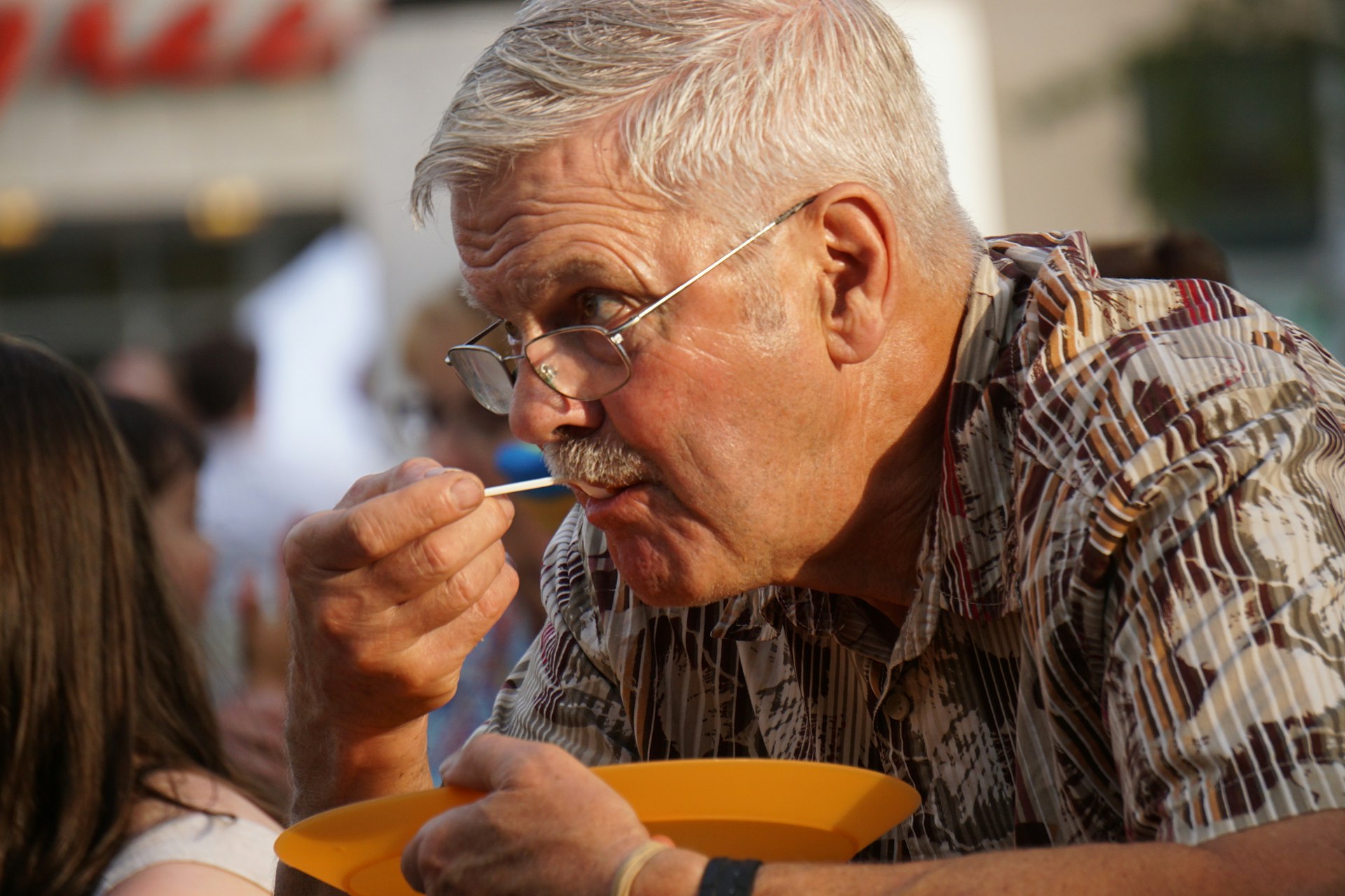 man in brown and black plaid button up shirt smoking cigarette